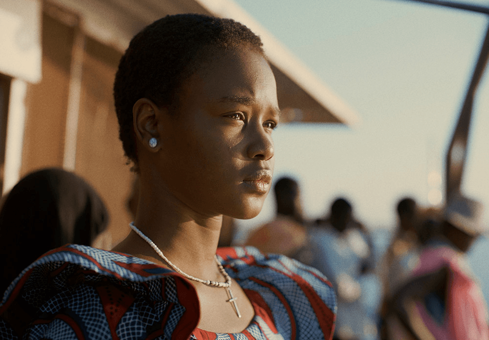 Smiling woman in red dress with green foliage background